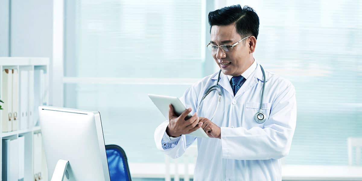 médico oriental com tablet site E-clínica Digital